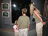 Jordan, Tyler, and Tanya looking at a giant bass fish