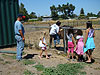 Jordan playing with a horse next to the field