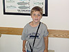 Tyler in front of a fish poster