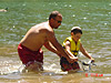 Ken helping Tyler ride up to shore