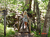 Tanya on a small bridge crossing a creek