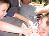 Tyler playing with Jordan in her carseat
