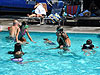 The kids playing games in the pool