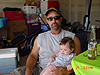 Ken holding Jordan at the party