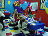 All of the party guests sitting down for pizza
