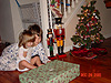 Tyler helping Jordan open another present