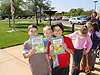 Tyler and Dakota holding up some books