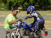 Ken helping Tyler get his bike started again