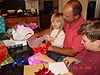 Jordan, Ken, and Tyler opening presents at Karyn and Sylvia's house